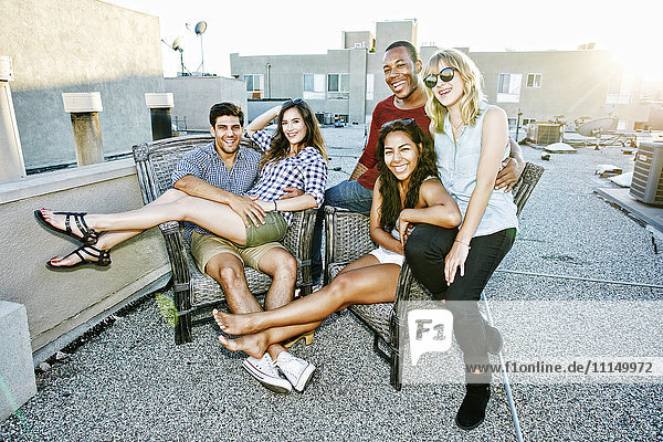 Friends relaxing on urban rooftop