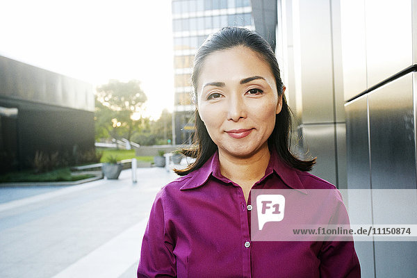 Asian businesswoman smiling outdoors