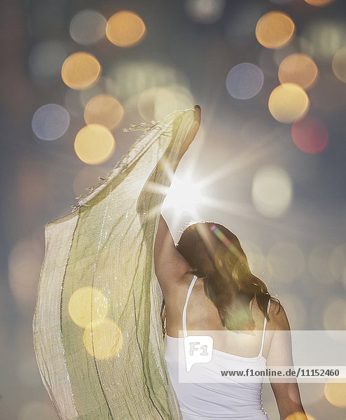Caucasian woman waving scarf