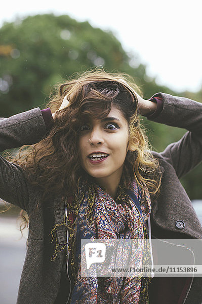 Middle Eastern woman tossing her hair outdoors