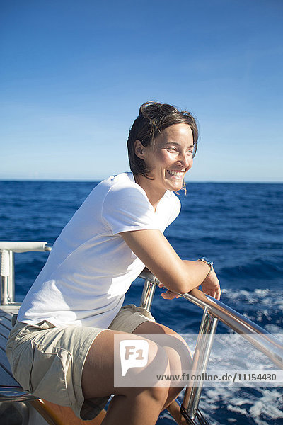 Caucasian woman sitting on boat deck