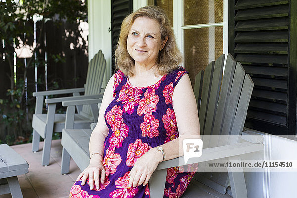Caucasian woman sitting on porch