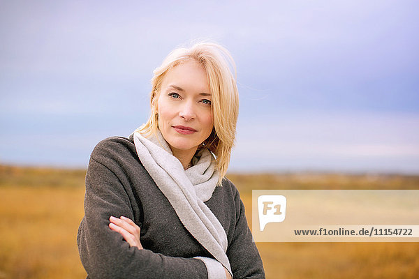 Caucasian woman standing in cold rural field