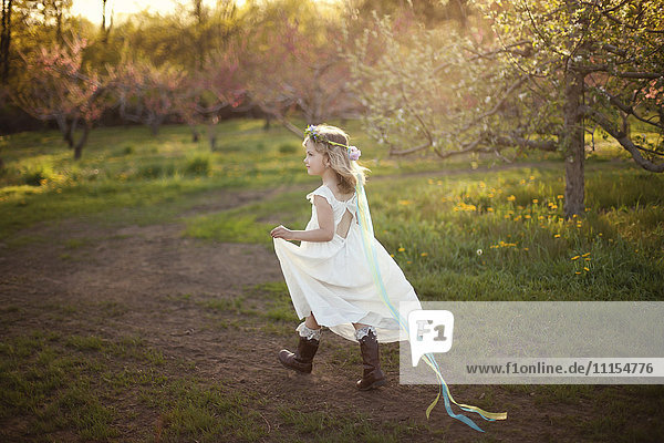 Caucasian girl walking on dirt path