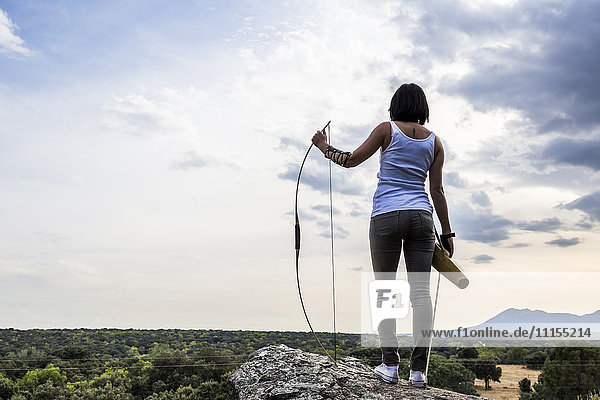 Archeress standing on a rock looking at view