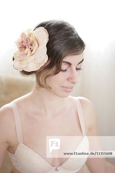 Caucasian woman wearing flower in her hair