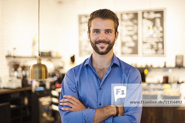 Portrait of confident young man in a cafe