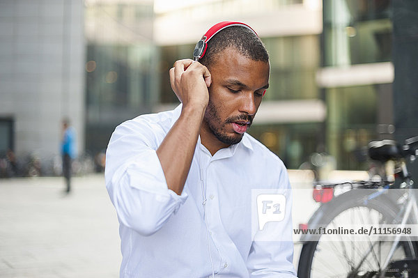 Businessman listening music with headphones