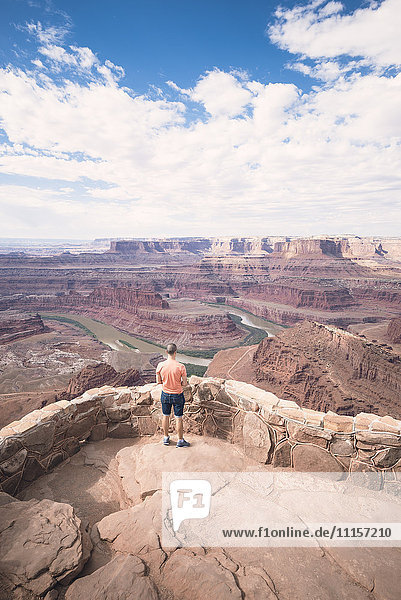 USA  Utah  Young man standing on Dead Horse Point looking to Colorado River