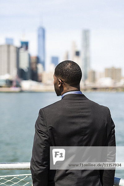 USA  Brooklyn  Rückansicht des Geschäftsmannes mit Blick auf die Skyline von Manhattan