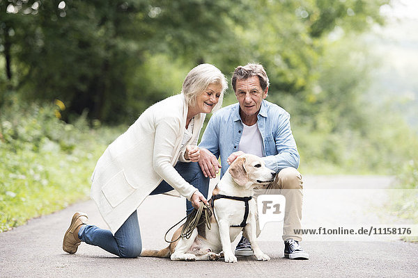 Senior couple with dog in nature