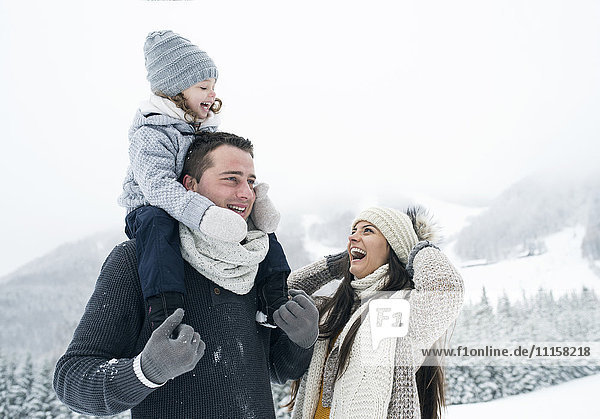 Happy family in winter landscape