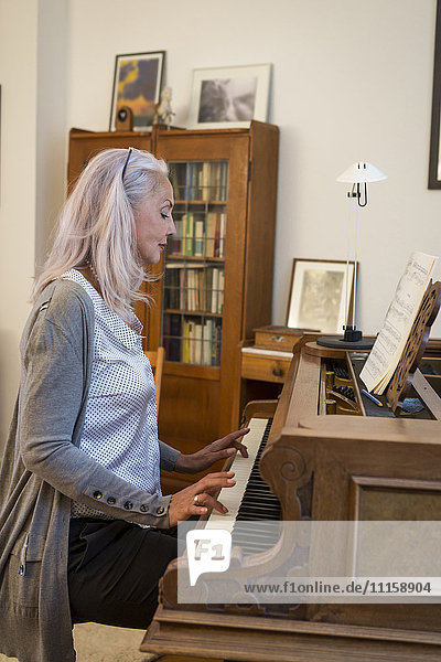 Woman playing piano at home