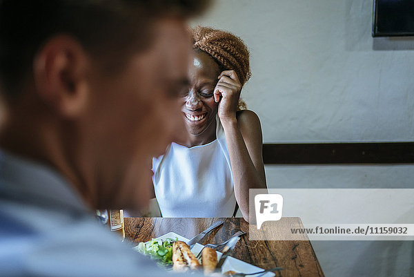Happy couple eating in restaurant