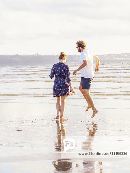 Couple talking a beach walk