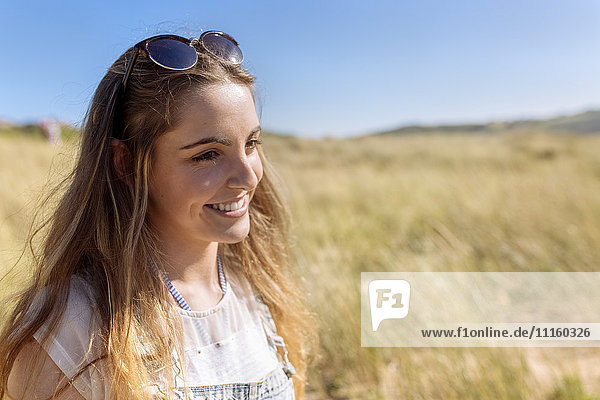 Portrait of smiling teenage girl on the beach