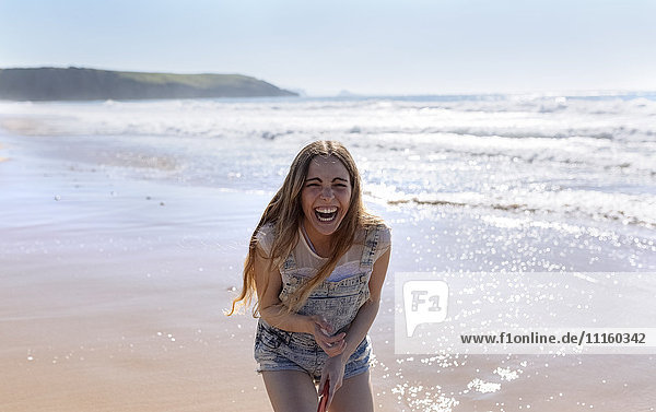 Laughing teenage girl on the beach