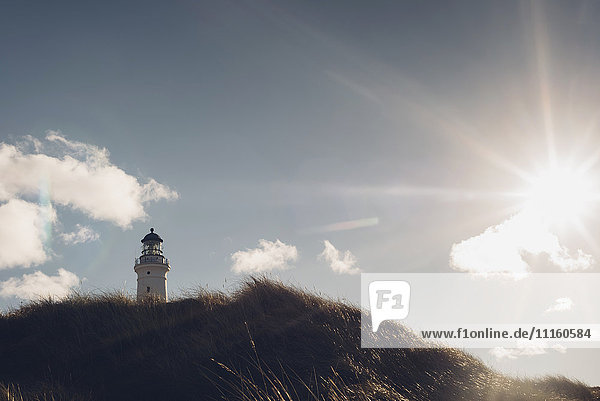 Denmark  Hirtshals  lighthouse at the coast in backlight