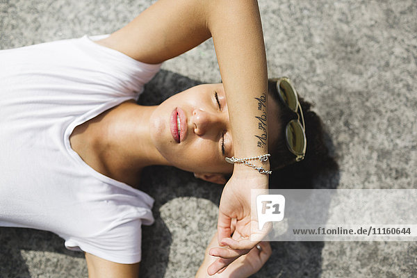 Relaxed young woman lying down enjoying the sunshine