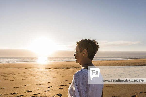 Frankreich  Bretagne  Finistere  Halbinsel Crozon  Frau bei Sonnenuntergang am Strand
