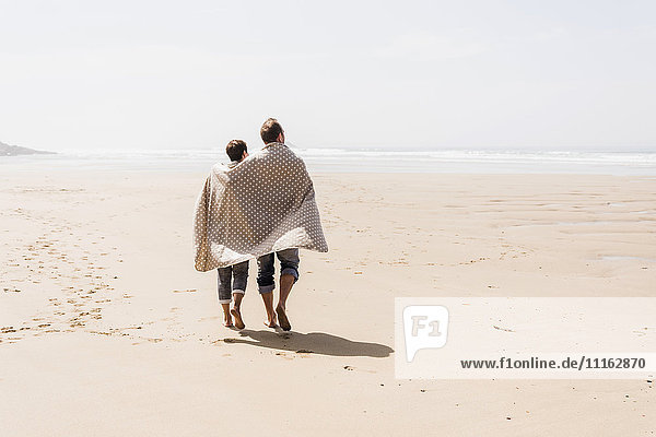 Mature couple walking on the beach