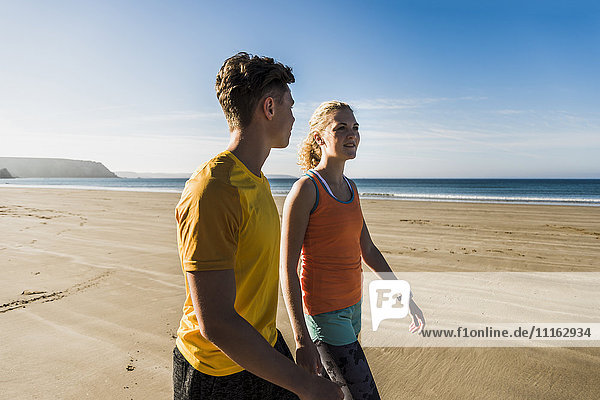 France  Crozon peninsula  sportive young couple walking on the beach