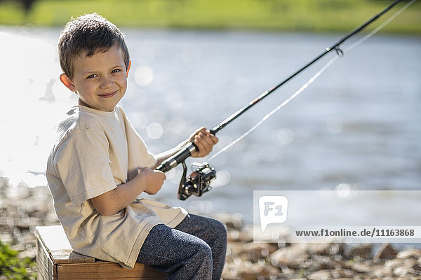Little boy fishing in lake