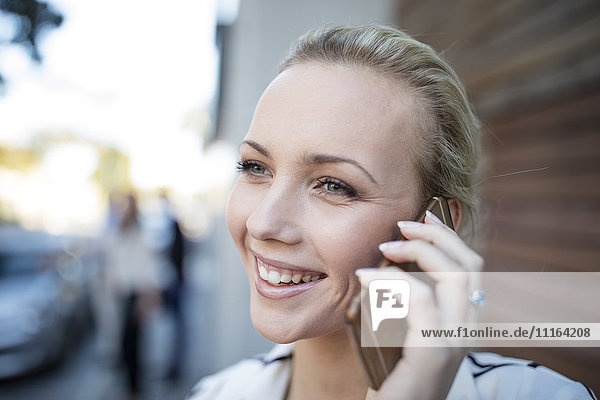 Smiling woman talking on cell phone