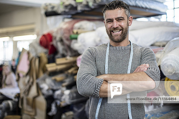 Portrait of confident tailor in workshop