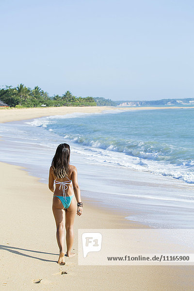Mixed Race girl walking on beach
