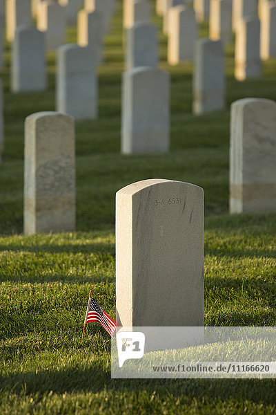 American flag at cemetery gravestone