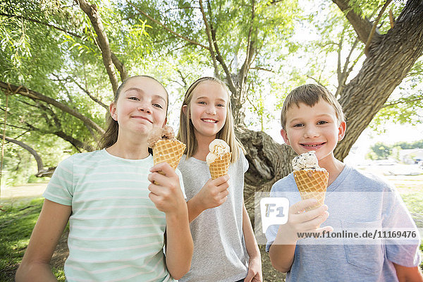 Caucasian boy and girls eating ice cream cones