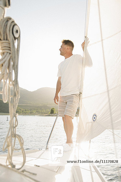 Portrait of a blond man on a sail boat.