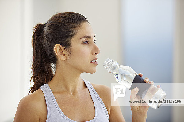 Woman drinking water post workout