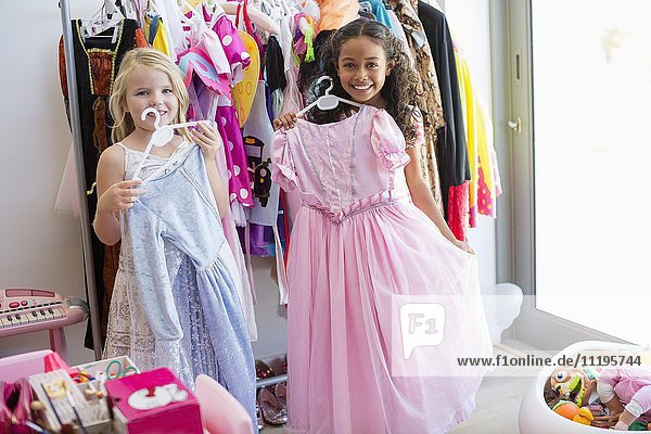 Two little girls trying on clothes