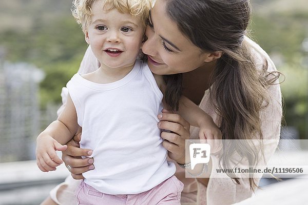 Close-up of happy mother playing with son