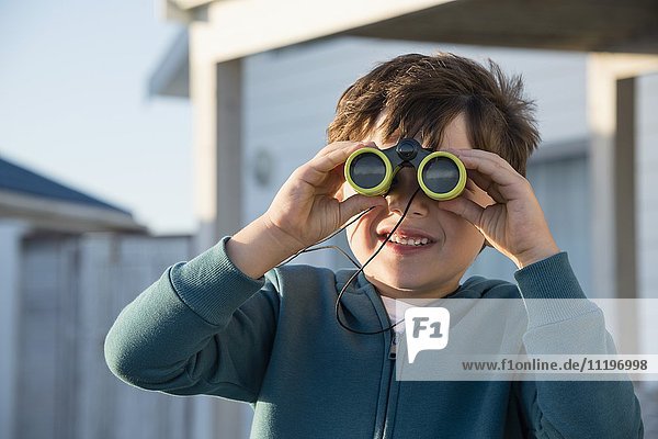 Boy looking through binoculars