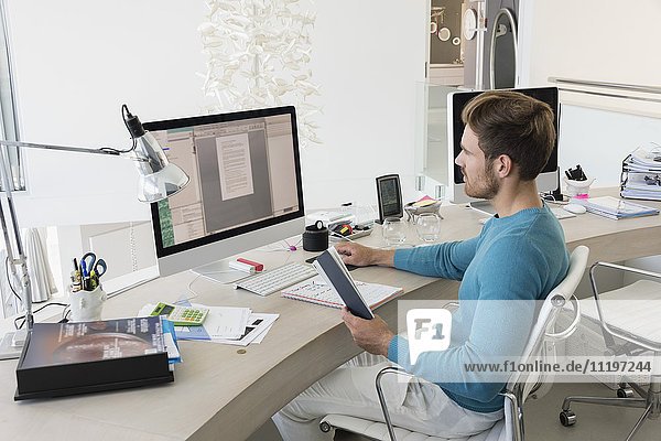 Young businessman working on computer in an office