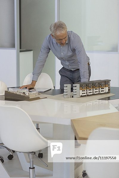 Design-Profi bei der Untersuchung eines Architekturmodells im Büro