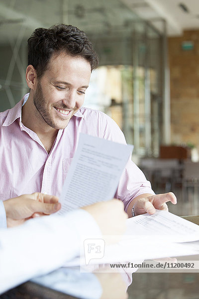 Man reviewing contract with real estate agent