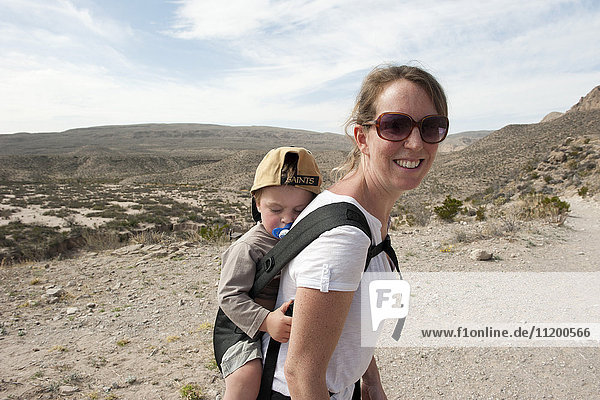 Mother and young son hiking in Big Bend National Park  Texas  USA