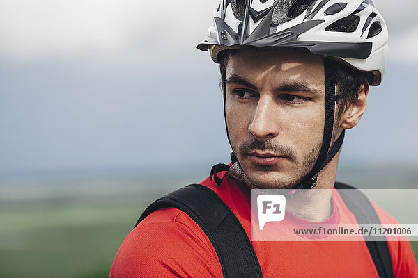 Portrait of confident man wearing bicycle helmet