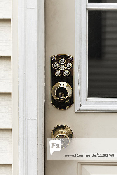 Close-up of shiny knob and locks on closed door
