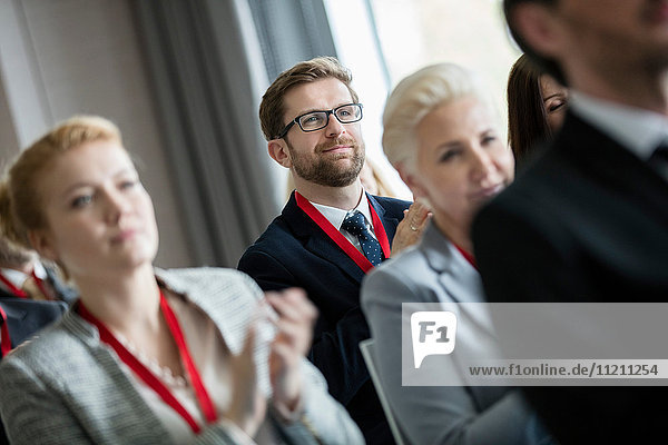 Business people applauding during seminar