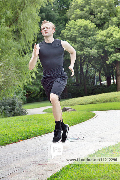 Fit and Healthy Caucasian man running in park