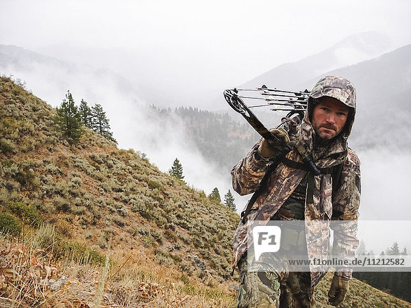 Bowhunter elk hunting in Mountains