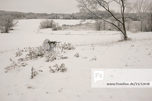 Bowhunter In Snow Ghillie Suit
