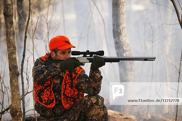 Whitetail Deer Hunter Aims Muzzleloader