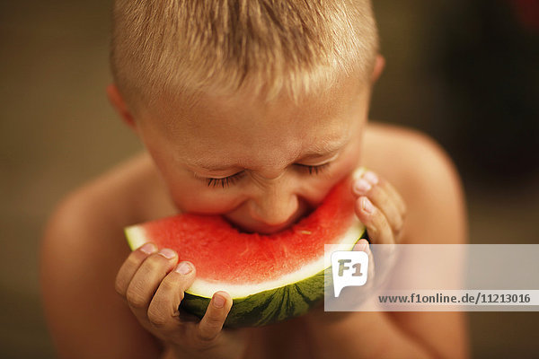 Boy Eating A Slice Of Watermelon