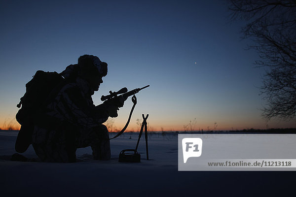 Silhouette Of Cold Weather Varmint Hunter